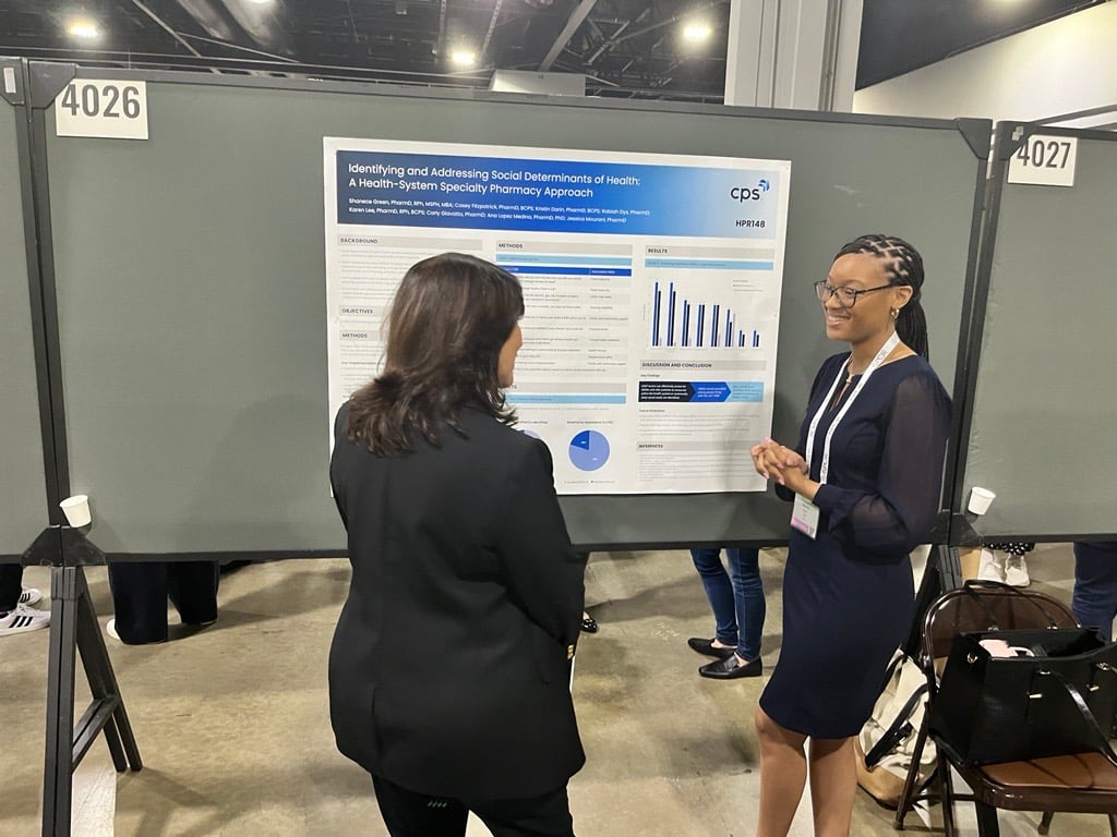 Dr. Green at ISPOR 2024 discussing the findings from her poster with an attendee.