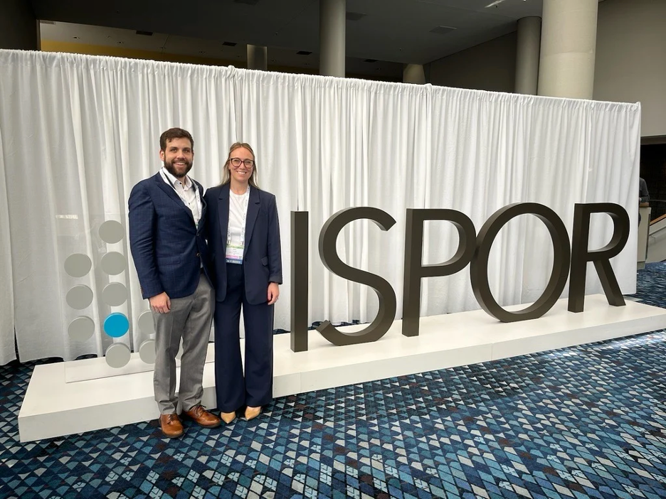 Drs. Carly Giavatto and Andrew Wash pose after their poster presentation at ISPOR.